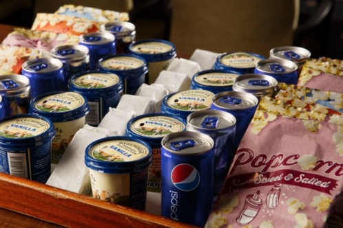 Tubs of ice cream and popcorn on a tray