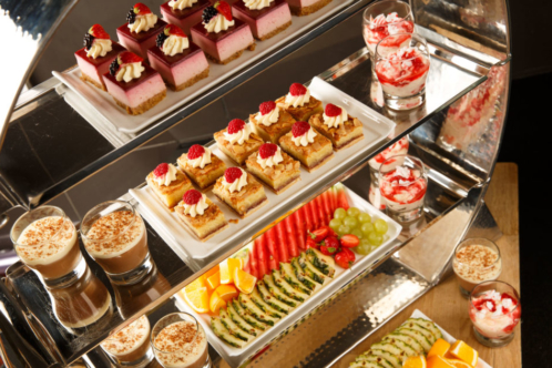 Brightly coloured desserts on a serving counter